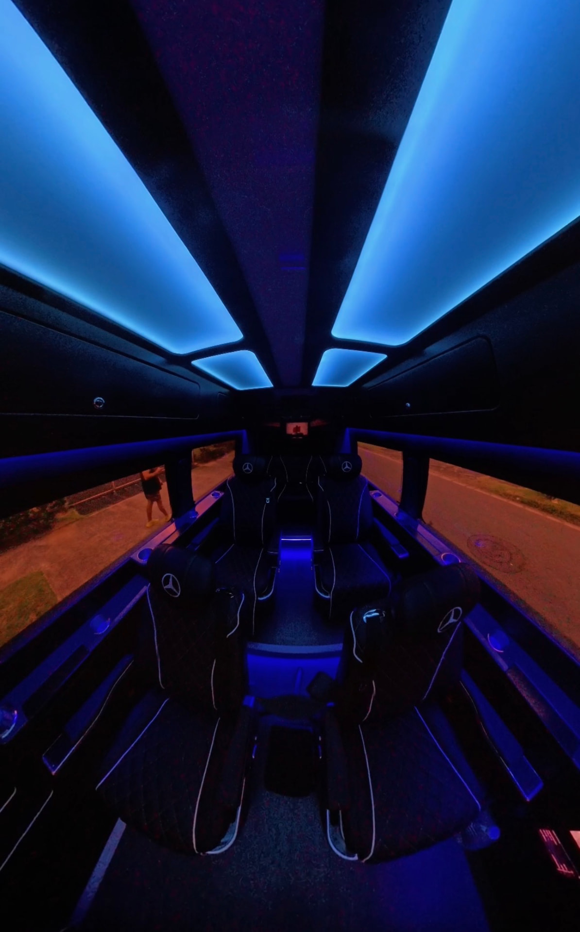 Sprinter cabin with blue ceiling ambient lighting and leather seating