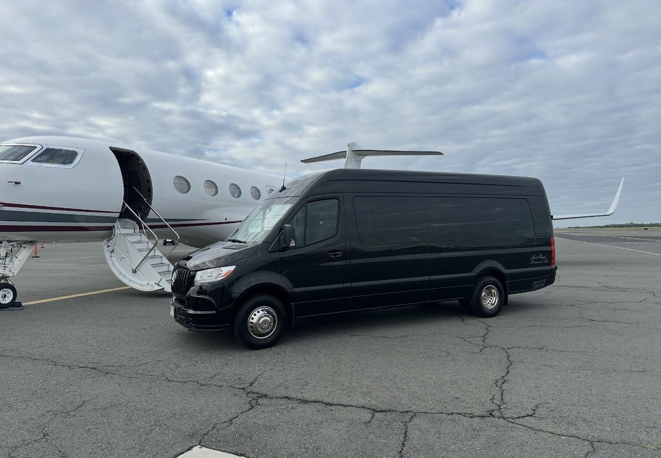 Black Mercedes Sprinter alongside a private jet with airstairs down